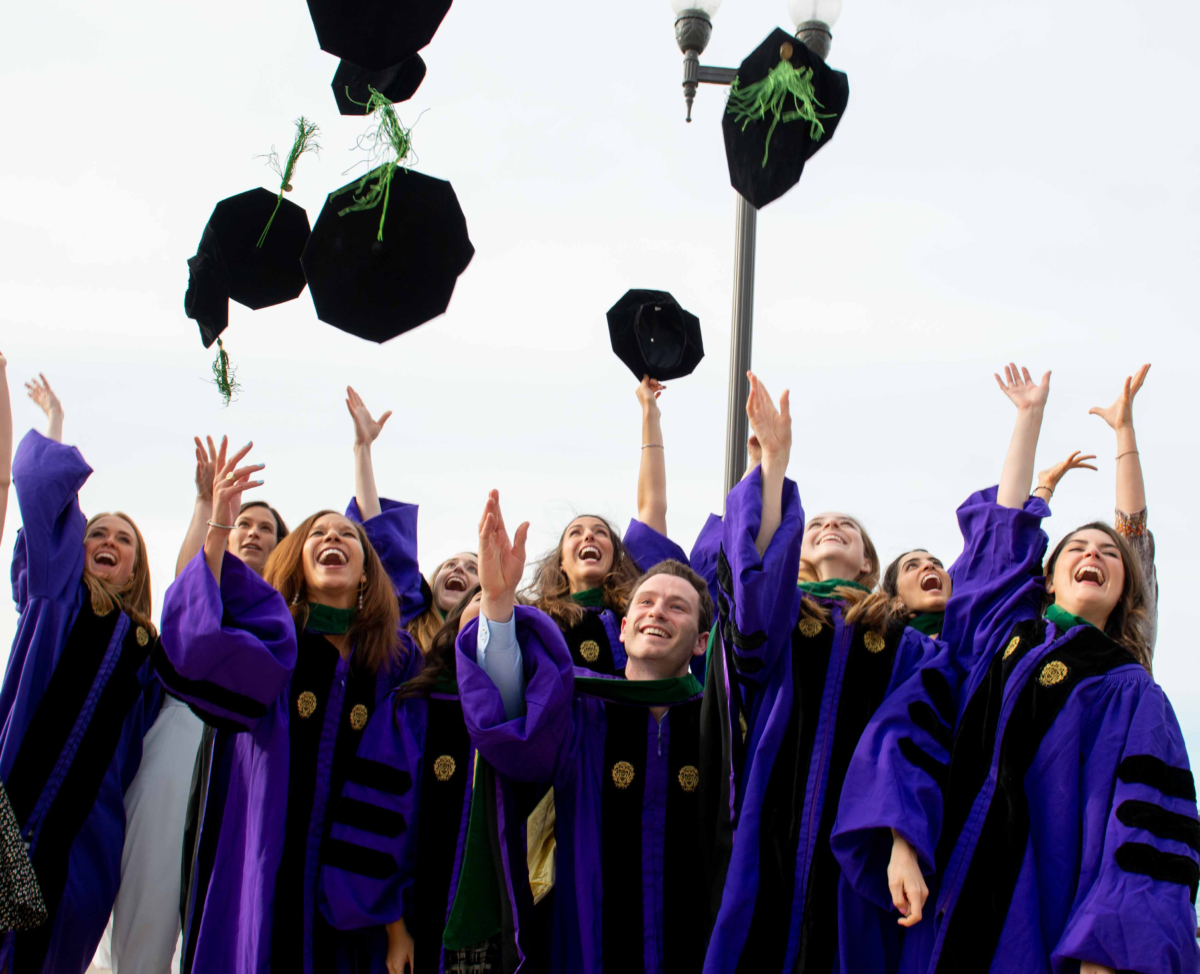 Photo of MD Class of 2019 throwing caps after graduation ceremony. 