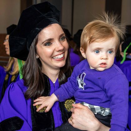 Photo of Roey Fuller, MD Class of 2019 graduate, holding her infant son. 